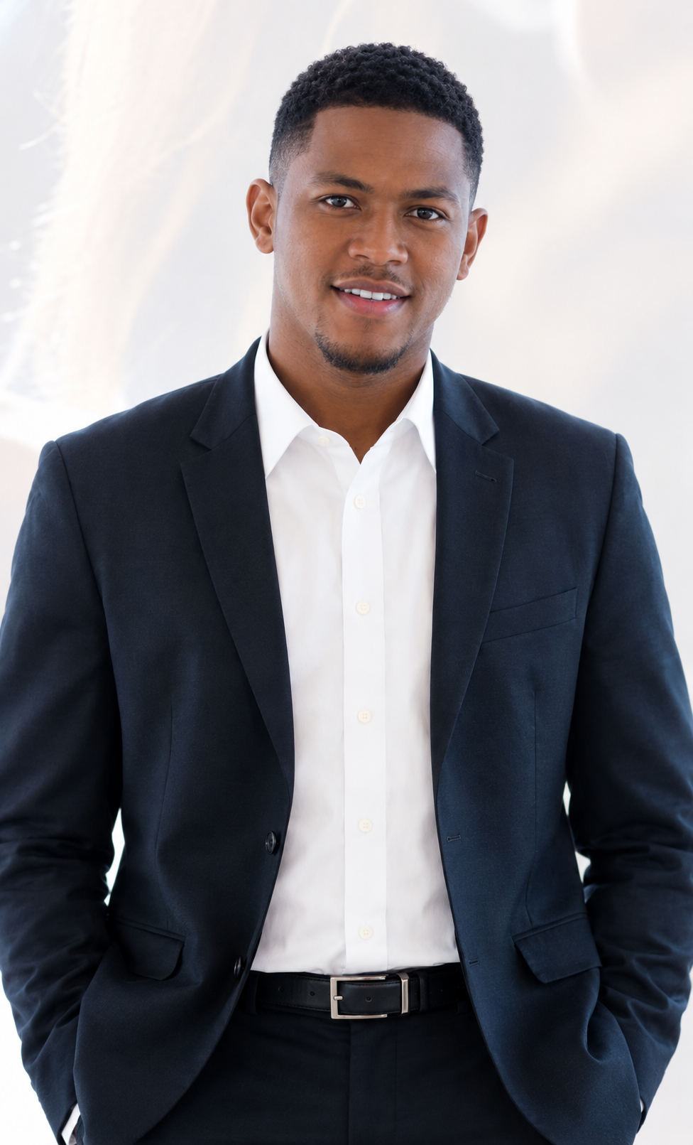 Smiling Black professional man in a navy suit and white shirt