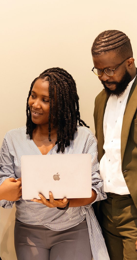 Team of colleagues reviewing work on a laptop together